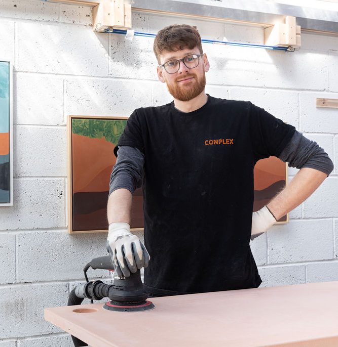 a man standing in a workshop